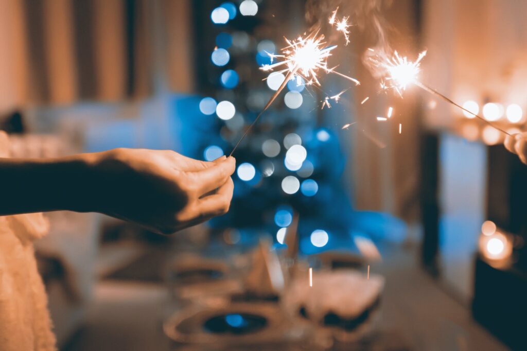 close up photograph of two person holding sparklers